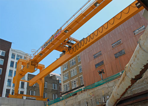 Large ground beams, 1.5 metres deep, have been cast 31 metres apart on which the rails for the Goliath crane legs run
